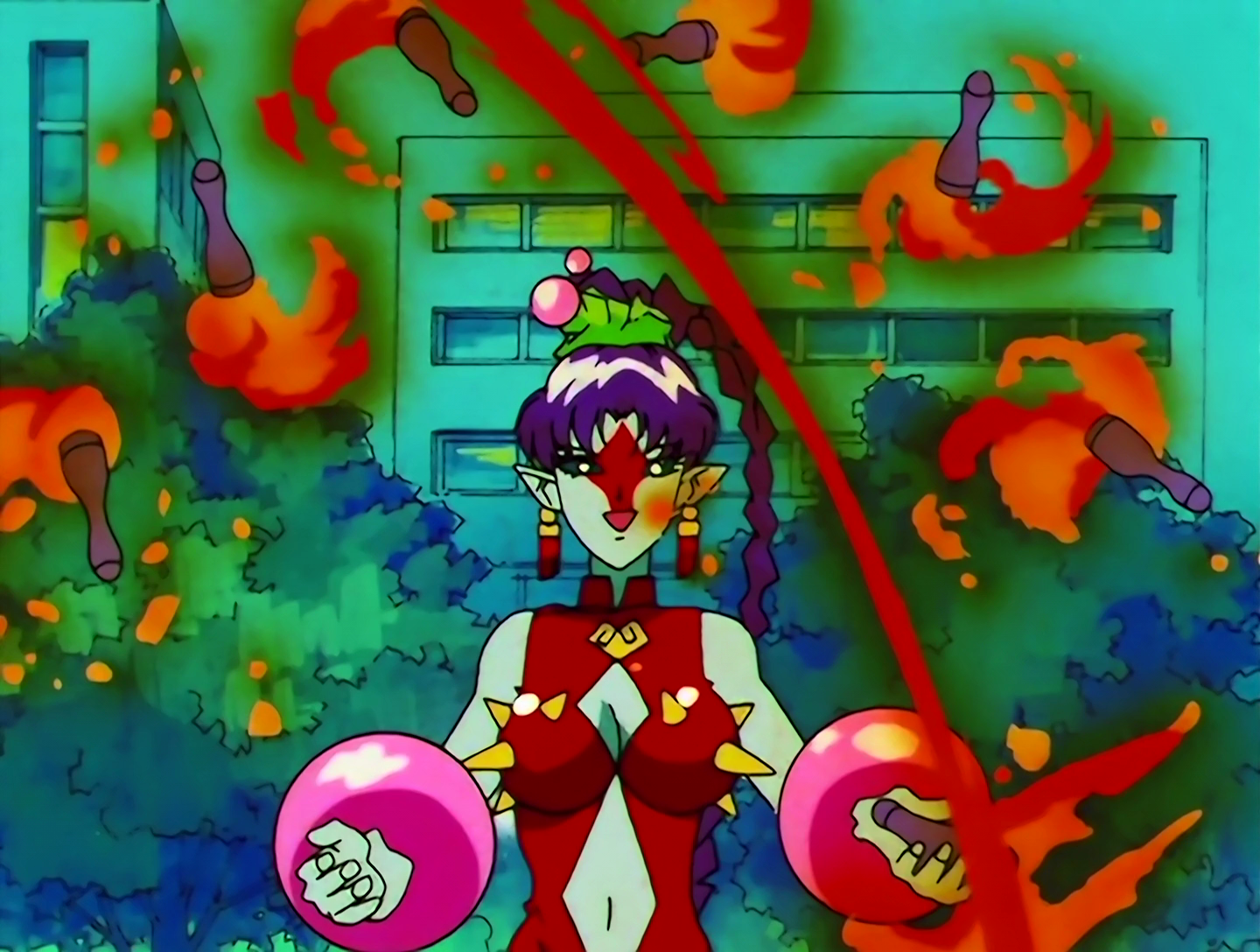 Otedamako, a Lemures from Sailor Moon episode 131. She hs light turquoise skin and purple hair, with a red diamond painted on her face. She’s wearing a red top with yellow spikes, and large pink bracelets that look spherical. She’s cheerfully juggling several flaming clubs.